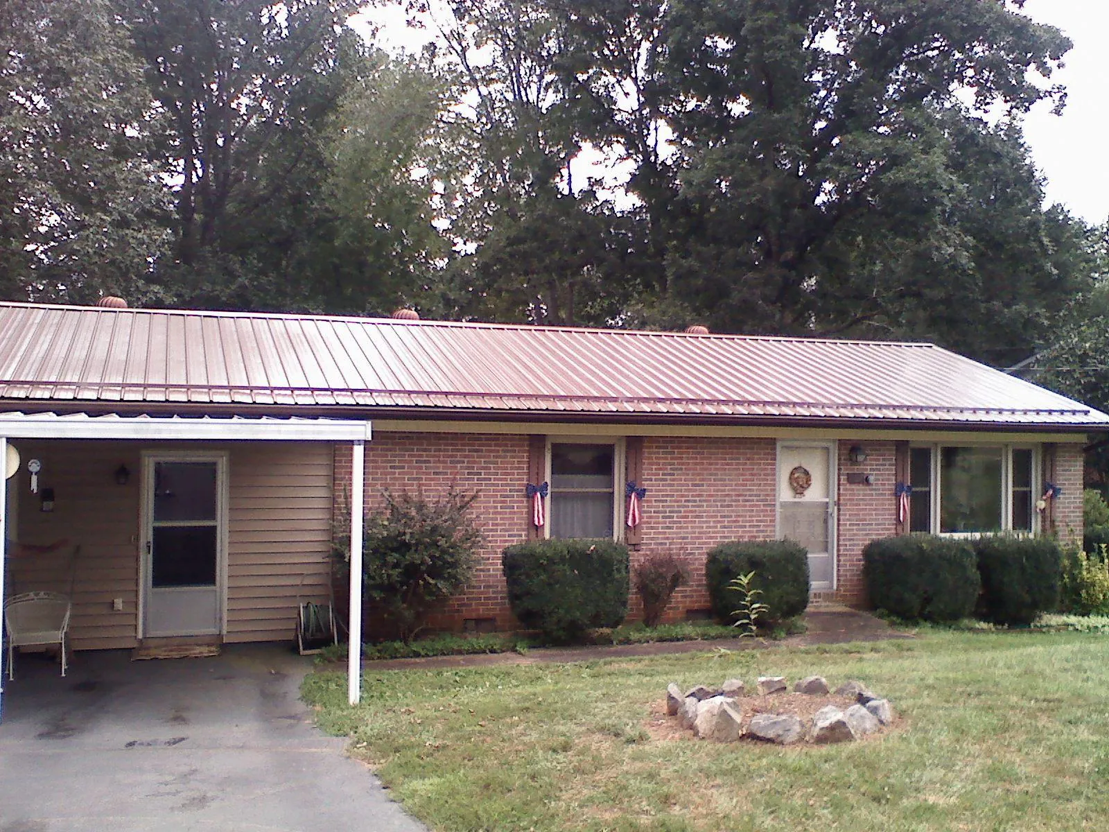 Bronze metal roof and carport on a brick ranch home — Roof Repair work by our crew in Mattapoisett