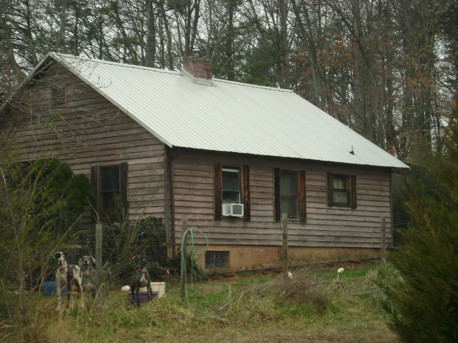 White metal roof on an old wood sided farmhouse, from a Metal Roof Installation job in Mattapoisett
